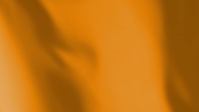 Orange flag waving animated background. Plain or monochrome colored textile material moving with the wind footage. Template for a design or a sports team symbol.
