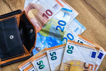 Banknotes of different denominations of euro on the desk