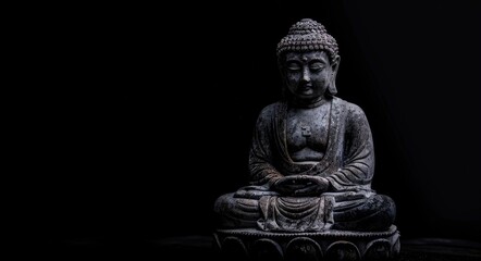 Obraz premium Buddha In A Dark Background. Minimalist Design of Buddha Idol for Meditation Wallpaper