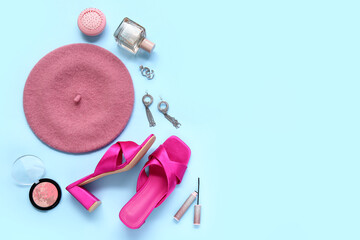 Beautiful composition with stylish pink heeled sandals and accessories on blue background