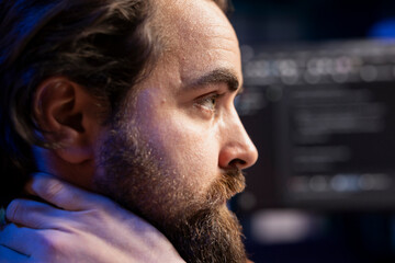 Cybersecurity expert in apartment using computer to look for security liabilities. Programmer focused on installing safeguard code on PC to prevent firewall breaches, close up shot