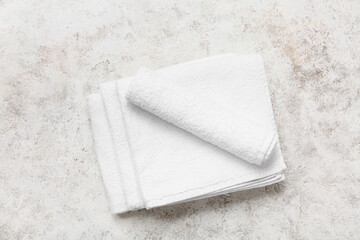 Clean soft towels on light grunge background