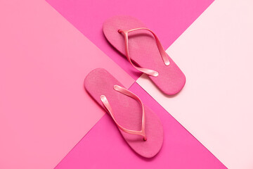 Pink flip flops on color background