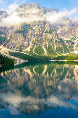 At Lake Braies in the morning on holiday in South Tyrol. A mountain in the Alps in the background