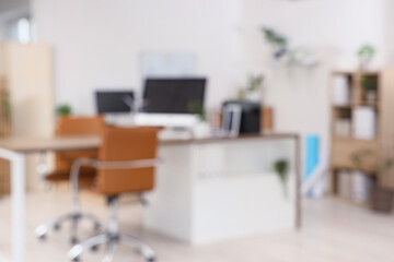 Blurred view of engineer's office with workplace and plants