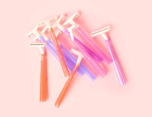 Different razors on pink background, closeup