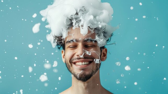 portrait of a man with a lot of shampoo foam on his head on blue background