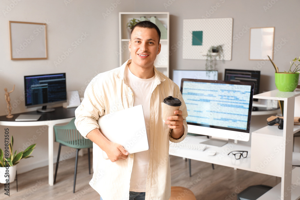 Canvas Prints handsome programmer with laptop and coffee cup in office