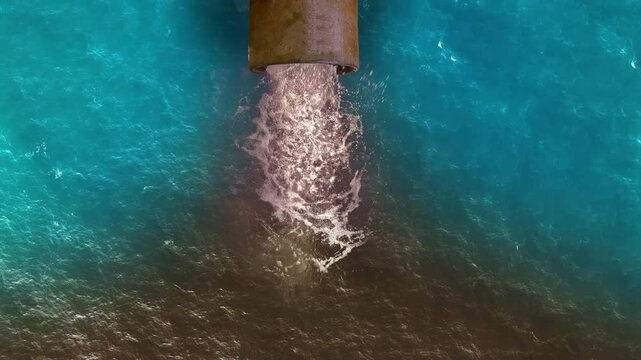 Dirty water pours out of the pipe into the ocean. Water pollution, environment contamination concept. 