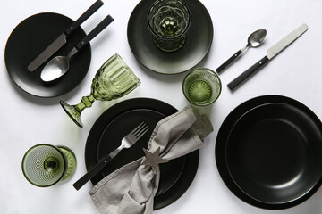 Beautiful table setting with black tableware on white background