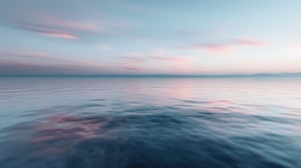 The ocean horizon at dusk with a serene blend of pink and blue tones, creating a calming ambiance and highlighting the beauty of the transitional time of day.