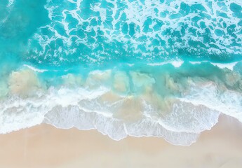 Top view of turquoise ocean waves rolling onto a soft sandy beach, capturing a perfect beach day.