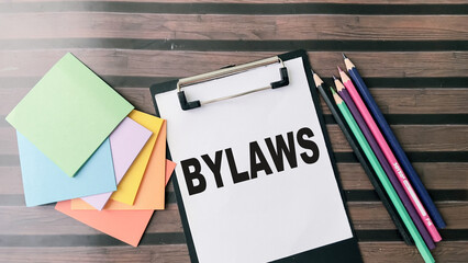 Concept of Bylaws write on paperwork isolated on wooden background.