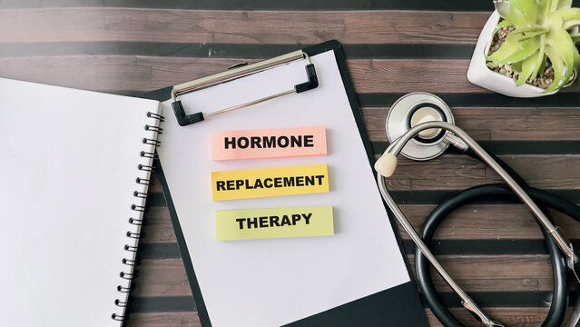 Concept of Hormone Replacement Therapy write on sticky notes isolated on Wooden Table.