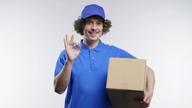 Positive postal courier man with hands sign OK, okay. Happy postman on white.