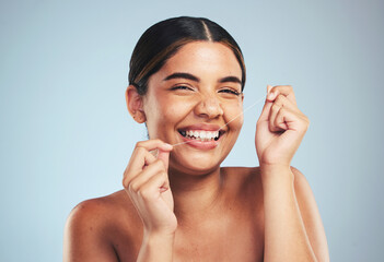 Woman, portrait and smile to floss teeth in studio for dental hygiene, care and gum gingivitis on...