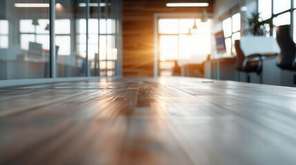 An open office area illuminated by the warm glow of sunset, showcasing wooden flooring and modern office furniture, evoking a sense of calm and productivity.