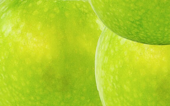 Green apple skin texture smooth background. Suitable for additional design projects.