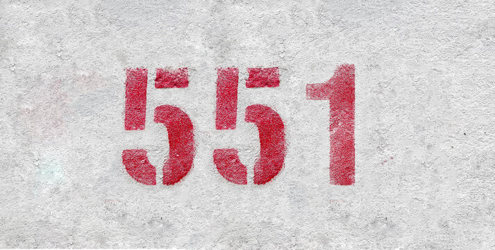 Red Number 551 on the white wall. Spray paint.
