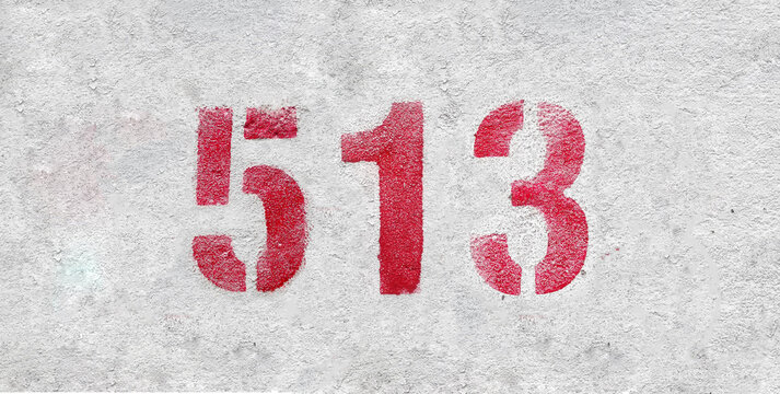 Red Number 513 on the white wall. Spray paint.
