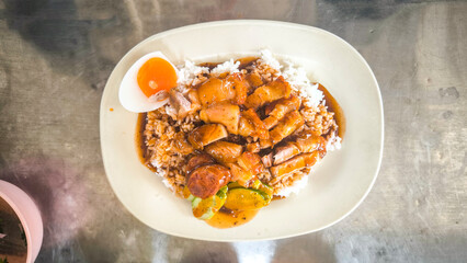 Crispy pork rice on a white plate on the dining table