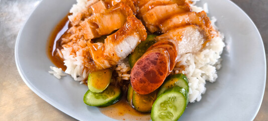 Crispy pork rice on a blue plate on the dining table