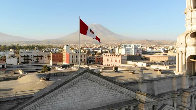 aerial view of the national flag of peru with the misti volcano and the cathedral of Arequipa