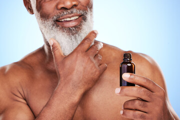 Black man, serum and beard treatment in studio, senior wellness and bottle on blue background. Elderly person, hydration and essential oil for skincare, application and moisturizing for dermatology