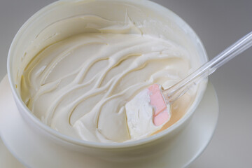 White bowl filled with homemade vanilla butter cream.