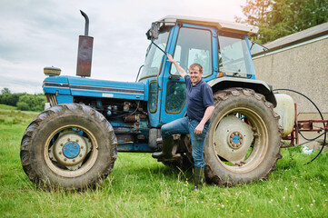 Tractor, farm and portrait of man in field for farming, harvest production and horticulture. Agriculture, countryside and farmer with machine, truck and vehicle for sustainability, produce and nature