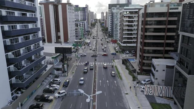 Drone flies west along Av. Pres. Epit&aacute;cio Pessoa after sunset in Joao Pessoa, Brazil