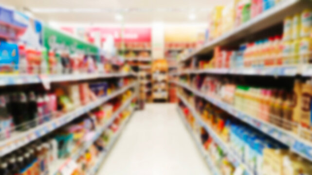 blurry image of snack display racks such as cookies, biscuits, nuts and other snacks in a super market