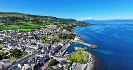 Aerial view of Carnlough Village Glencloy on the Irish Sea Antrim Northern Ireland on a sunny day with a blue sky