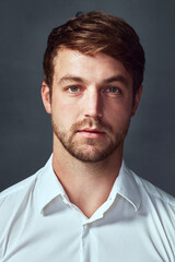 Fototapeta premium Portrait, serious and man in studio, proud and professional for government, special agent and bodyguard. Grey background, employee and service for protection in agency and confident in Milwaukee