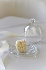 Coconut white macaron on a glass plate