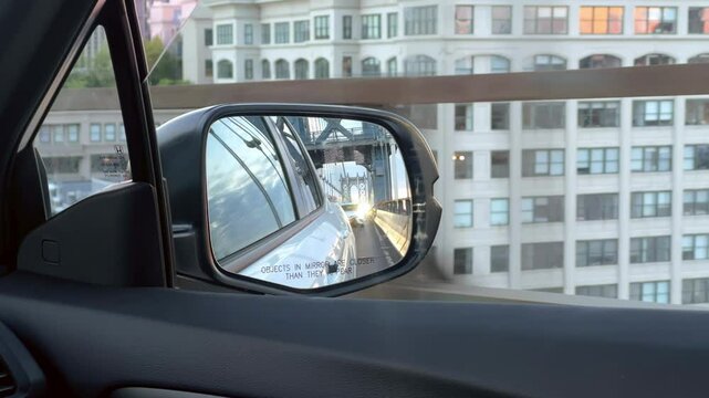 driving passenger side mirror view of Manhattan Bridge to Brooklyn in New York City NYC
