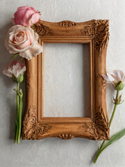A wooden picture frame adorned with fresh flowers.