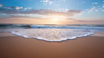 Sunrise over ocean waves on a sandy beach landscape view