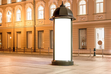 Mockup Of Round Lightbox Screen In A City Square At Night. Retro Style Advertising Billboard In Front Of The Luxury Retail Showcase
