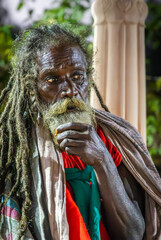 indian old saint with dramatic presence with tresses hair and beard at evening