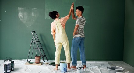 Couple, people and high five with painting wall for house renovations, upgrade and bonding. Home, relationship and happy or smile for fun with support, care and teamwork for love with partner