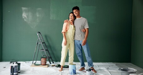 Couple, people and smile with painting wall for house renovations, upgrade and bonding. New home,...