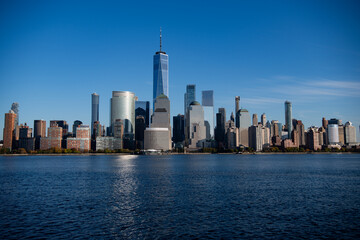 Fototapeta premium New York, United States. New York city skyline in Midtown Manhattan. USA, NYC, NY, Manhattan. American big city. Lower Manhattan skyline. New York from New Jersey. Downtown Manhattan with blue sky.