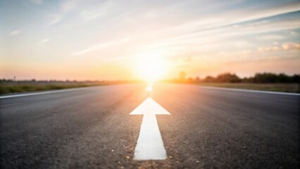 White Arrow on Asphalt Road Leading to Sunset
