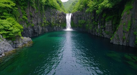 Stunning waterfall in lush green canyon