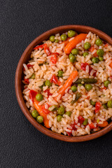 Delicious boiled rice with vegetables carrots, peas and peppers