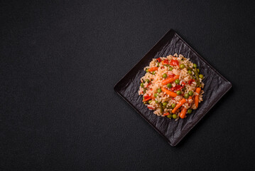 Delicious boiled rice with vegetables carrots, peas and peppers