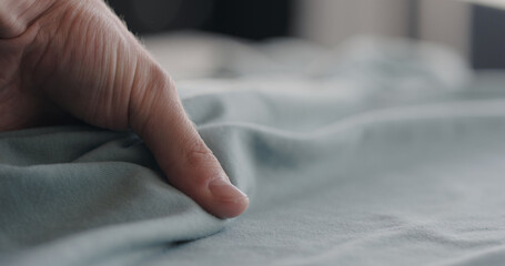 man touching cyan cotton clothes closeup