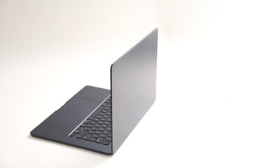 Side view of laptop with blank screen isolated on white background. Selective focus.