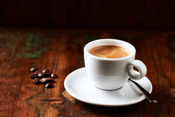 Cup of coffee on wooden background. Close up.
